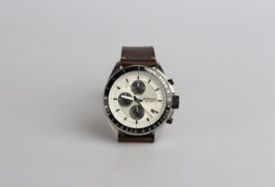 round silver-colored Fossil chronograph watch at 9:22 with brown leather band